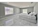 Bright bedroom with marble floors, two large windows, and a comfortable bed at 726 S Stone St, Deland, FL 32720