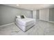 Bedroom with marble floors, bright window, neutral color walls, and a comfortable bed at 726 S Stone St, Deland, FL 32720