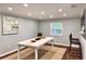 Bright dining room featuring a large extendable table, stylish lighting, and access to a kitchen bar at 726 S Stone St, Deland, FL 32720