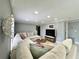 Inviting living room with marble tile floors, recessed lighting, a neutral sectional and a bright window at 726 S Stone St, Deland, FL 32720