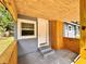 Covered porch with tongue-and-groove ceiling, wooden columns, and exterior access door at 726 S Stone St, Deland, FL 32720