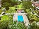 An aerial view of the swimming pool with crystal blue water and lots of seating for the residents at 728 Ramirez Ave, The Villages, FL 32159