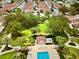 Aerial view showcasing pool, cabana, and verdant landscaping in a serene community setting at 728 Ramirez Ave, The Villages, FL 32159