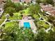An aerial view of a pool, cabana, with nice surrounding grass and tree coverage in a community at 728 Ramirez Ave, The Villages, FL 32159