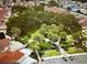 Aerial view of park featuring trees, green lawns, walking paths, and surrounding residential homes at 728 Ramirez Ave, The Villages, FL 32159