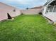 A charming backyard features a well-maintained lawn and privacy fence, creating a relaxing outdoor space at 728 Ramirez Ave, The Villages, FL 32159
