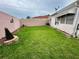 A charming backyard features a well-maintained lawn and privacy fence, creating a relaxing outdoor space at 728 Ramirez Ave, The Villages, FL 32159