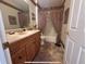 Bathroom featuring vanity with tile flooring, neutral paint and bathtub with curtain at 728 Ramirez Ave, The Villages, FL 32159