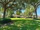 Lush community green space, showcasing mature trees, manicured lawns, and beautiful landscaping in a tranquil setting at 728 Ramirez Ave, The Villages, FL 32159