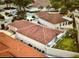 Aerial view of a single-Gathering home with a red tile roof, white exterior walls, and a fenced-in backyard at 728 Ramirez Ave, The Villages, FL 32159