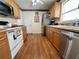 Efficient kitchen featuring wood cabinets, modern appliances, laminate floors and ample counter space at 728 Ramirez Ave, The Villages, FL 32159