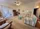 Cozy living room featuring plush seating, vaulted ceilings, and French doors leading to the outdoor area at 728 Ramirez Ave, The Villages, FL 32159