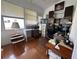 Functional office space with natural light and wooden floors and many storage shelves at 728 Ramirez Ave, The Villages, FL 32159