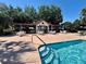 Resort-style pool featuring shaded seating areas, clear blue water, and convenient stair access at 728 Ramirez Ave, The Villages, FL 32159