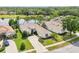 Aerial view of a beautiful home with manicured lawn and a lake view at 8043 Pine Hollow Dr, Mount Dora, FL 32757
