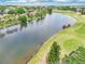 Overhead view showcasing the lake surrounded by golf course and neighborhood at 8043 Pine Hollow Dr, Mount Dora, FL 32757