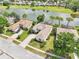 Overhead view displaying the property's prime location, adjacent to a lake and a golf course at 8043 Pine Hollow Dr, Mount Dora, FL 32757