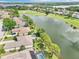 Aerial view of waterfront homes, golf course and community featuring mature trees and beautiful landscaping at 8043 Pine Hollow Dr, Mount Dora, FL 32757
