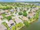 Community aerial showcasing lakefront homes, lush greenery and golf course at 8043 Pine Hollow Dr, Mount Dora, FL 32757