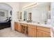 Bathroom boasts a large mirror, vanity with seating and decoratively-framed view into the bedroom at 8043 Pine Hollow Dr, Mount Dora, FL 32757