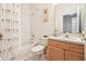 Classic bathroom features a tub with shower, sink vanity and tiled flooring at 8043 Pine Hollow Dr, Mount Dora, FL 32757