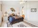 Comfortable bedroom boasts carpet, ceiling fan and artistic decor and decoratively-framed view into the bathroom at 8043 Pine Hollow Dr, Mount Dora, FL 32757
