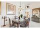 Formal dining area with elegant furnishings, artwork, chandelier, and views to other living areas at 8043 Pine Hollow Dr, Mount Dora, FL 32757