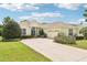 Lovely single-story home with a well-manicured lawn, flowerbeds, and an attached two-car garage at 8043 Pine Hollow Dr, Mount Dora, FL 32757