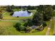 Scenic golf course view featuring a pond with a fountain and lush green landscaping at 8043 Pine Hollow Dr, Mount Dora, FL 32757