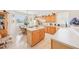 The airy eat-in kitchen offers plenty of natural light, with light wood cabinets and white countertops at 8043 Pine Hollow Dr, Mount Dora, FL 32757