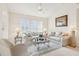 Bright living room showcases neutral furniture, a ceiling fan, and a picturesque view of the water at 8043 Pine Hollow Dr, Mount Dora, FL 32757