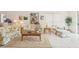 Bright living room with tile floors, area rug, and lots of natural light at 8043 Pine Hollow Dr, Mount Dora, FL 32757