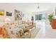 Bright living room features tile floors, area rug, and view of the lanai at 8043 Pine Hollow Dr, Mount Dora, FL 32757