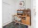 Cozy office area with wood desk, office chair, and carpet at 8043 Pine Hollow Dr, Mount Dora, FL 32757