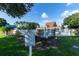 Community pool with posted rules, white fence, clubhouse in background, and shaded areas at 8043 Pine Hollow Dr, Mount Dora, FL 32757