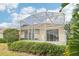 Large screened-in patio overlooks a green lawn, providing an inviting space for relaxation at 8043 Pine Hollow Dr, Mount Dora, FL 32757