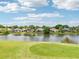 Scenic view of lakefront homes surrounded by lush greenery, offering a serene and picturesque setting at 8043 Pine Hollow Dr, Mount Dora, FL 32757