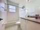 Bright bathroom featuring a tub with shower, white cabinets, and neutral-toned countertops at 860 Wolf Creek St, Clermont, FL 34711