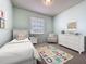 Charming bedroom with a twin bed, colorful rug, and coordinating dresser and nightstand set at 860 Wolf Creek St, Clermont, FL 34711