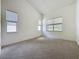 Neutral bedroom features a large window overlooking green foliage at 860 Wolf Creek St, Clermont, FL 34711