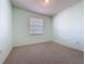 Comfortable bedroom showcasing carpet flooring, a light fixture, and natural light from the window at 860 Wolf Creek St, Clermont, FL 34711