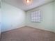 Empty bedroom showcasing neutral carpet, and a window offering plenty of natural light at 860 Wolf Creek St, Clermont, FL 34711