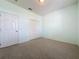 Spacious bedroom featuring a closet and ample wall space with neutral carpeting and a ceiling light fixture at 860 Wolf Creek St, Clermont, FL 34711