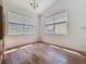 Dining room boasts wood floors, two large windows, and chandelier lighting at 860 Wolf Creek St, Clermont, FL 34711