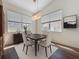 Dining room boasts modern light fixture, wood floors, and neutral tones at 860 Wolf Creek St, Clermont, FL 34711