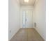 Bright entryway features neutral tile floors and a white front door with sidelights at 860 Wolf Creek St, Clermont, FL 34711