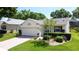 Beautiful single-story home with a brick driveway and manicured front yard landscaping at 860 Wolf Creek St, Clermont, FL 34711