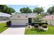 Charming single-story home features a brick driveway and meticulously landscaped front yard, with attached two-car garage at 860 Wolf Creek St, Clermont, FL 34711