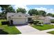 Charming single-story home features a brick driveway and meticulously landscaped front yard, and attached two-car garage at 860 Wolf Creek St, Clermont, FL 34711