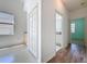 Hallway displaying views of the bath and bedroom offering neutral color schemes with carpet and hardwood floors at 860 Wolf Creek St, Clermont, FL 34711